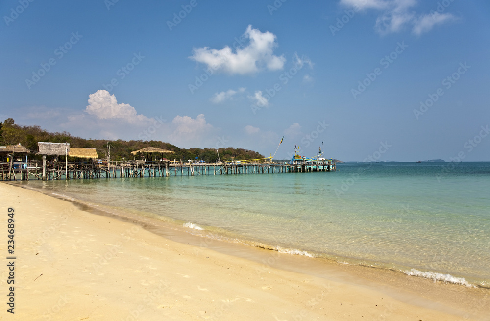 beautiful beach with wooden pier in bay