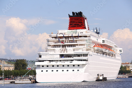 luxury white cruise ship shot at angle at water level