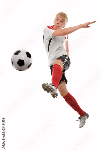 Soccer player kicking the ball isolated on white © Alexander Raths