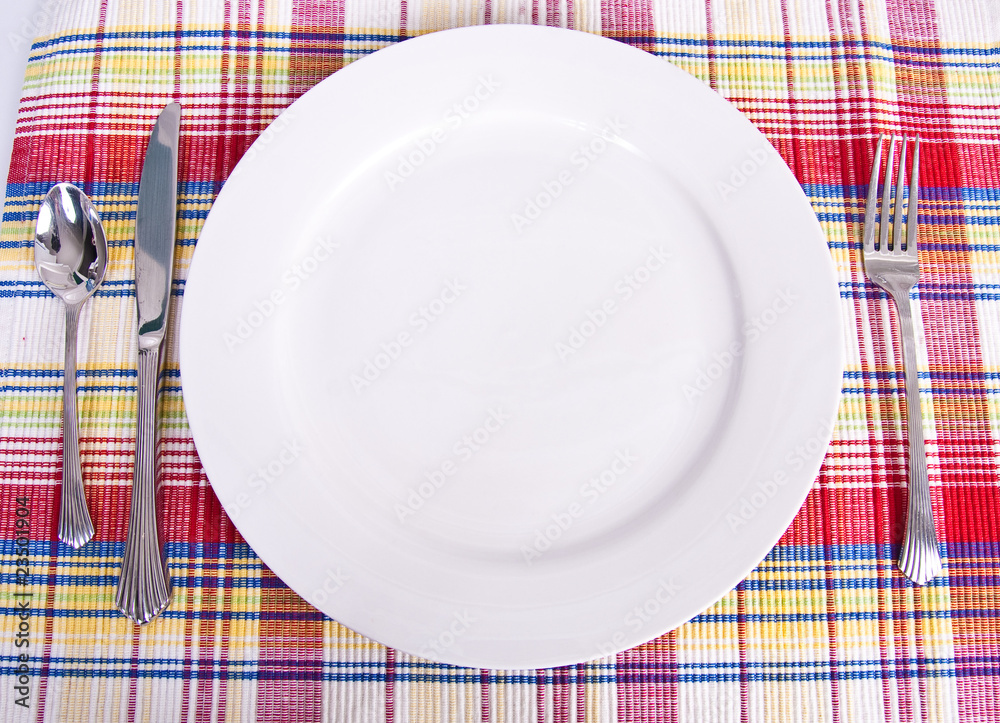 White Plate and Silver on Colorful Placemat White Plate and Silver on Colorful Placemat