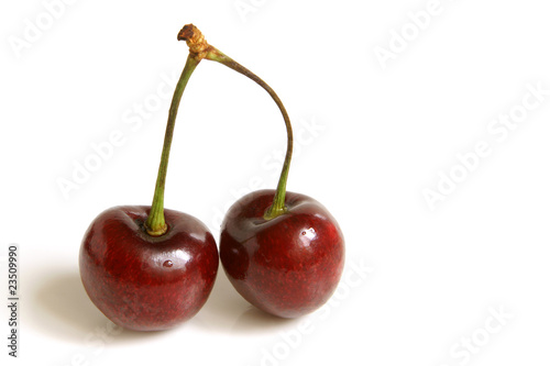 Two red cherries isolated on a white background