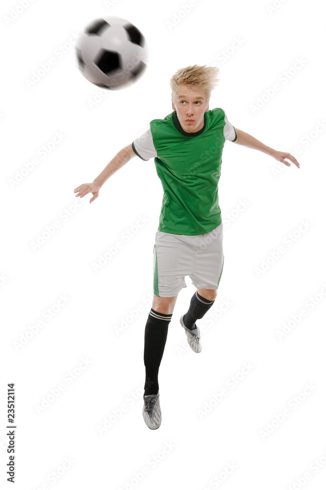 Soccer player kicking the ball isolated on white