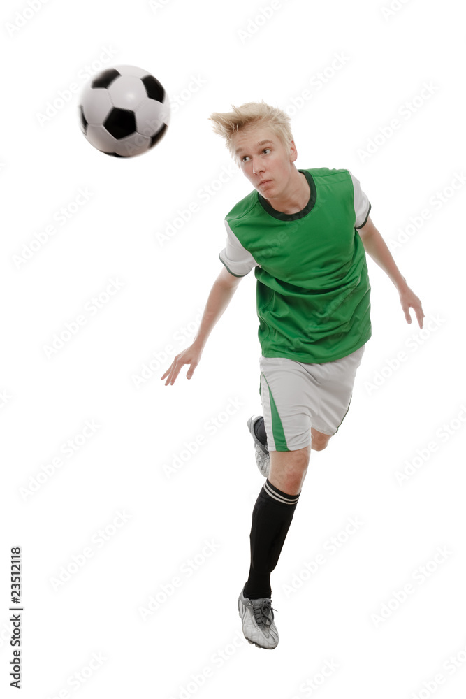 Soccer player kicking the ball isolated on white