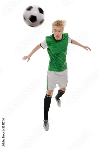 Fototapeta Naklejka Na Ścianę i Meble -  Soccer player kicking the ball isolated on white