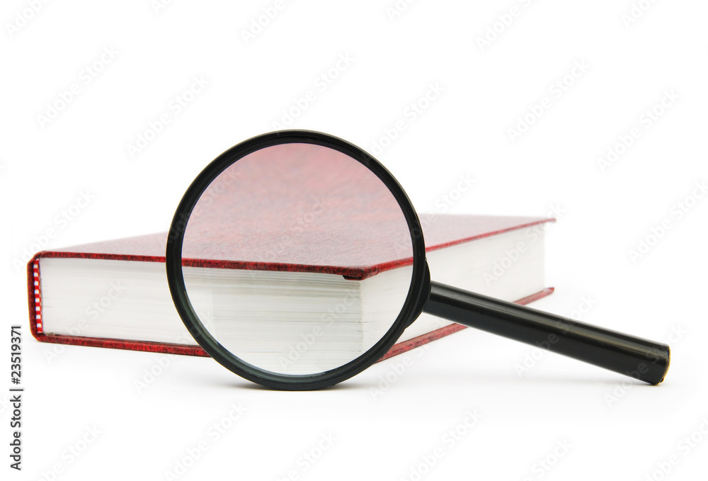 Magnifying glass over the stack of books Magnifying glass over the stack of books