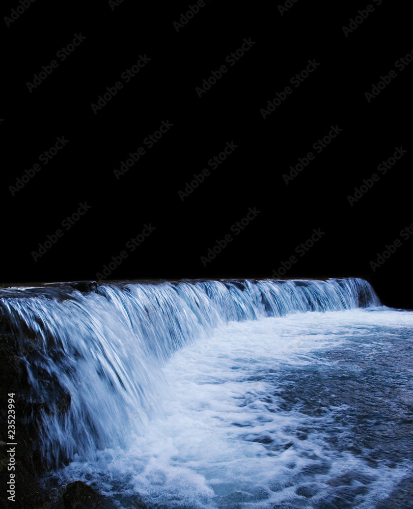 Fototapeta premium A large river waterfall in the dark. Copyspace