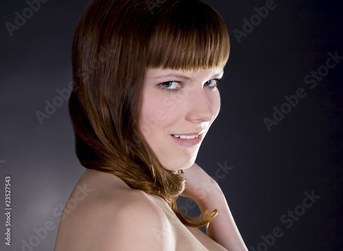 beauty young pretty girl with straight hair over dark