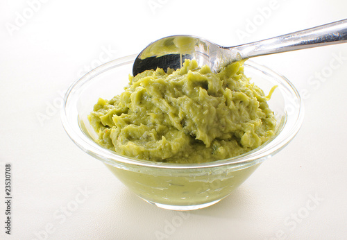 Cuacamole in a glass bowl with spoon