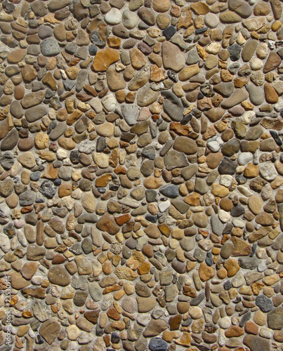 concrete with gray white orange brown stone pebbles wall