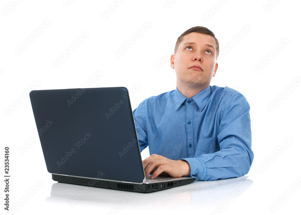 young man working on his laptop computer young man working on his laptop computer