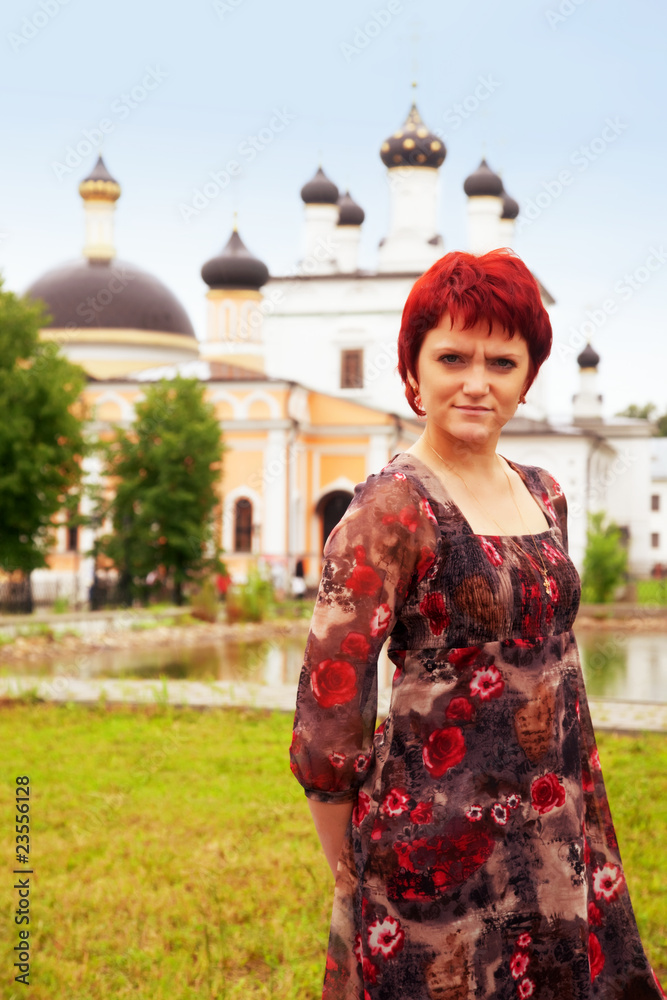 Fototapeta premium Young girl in front of the christian church.