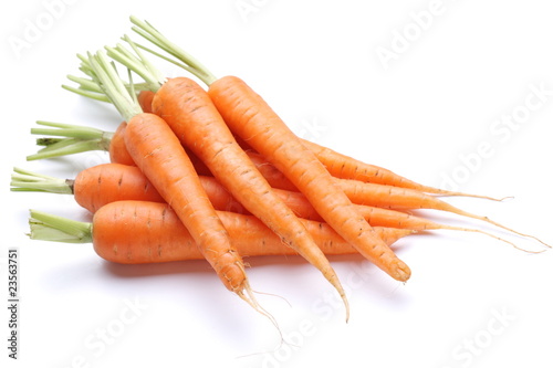 Ripe fresh carrots on a white background.