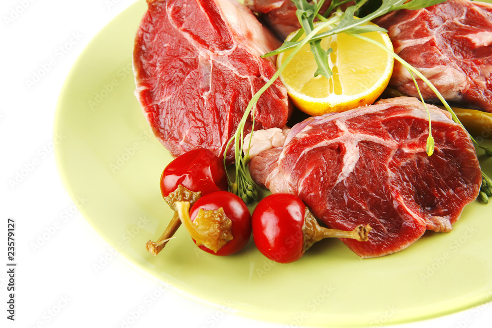 Fototapeta premium uncooked meat medallion on green
