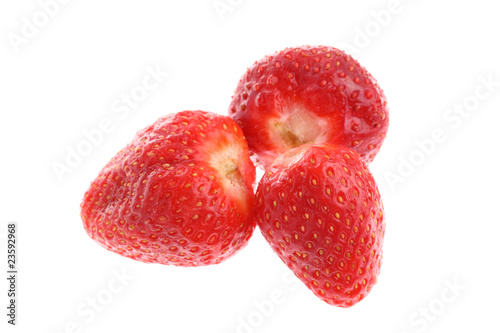 Three red juicy ripe strawberries isolated on white
