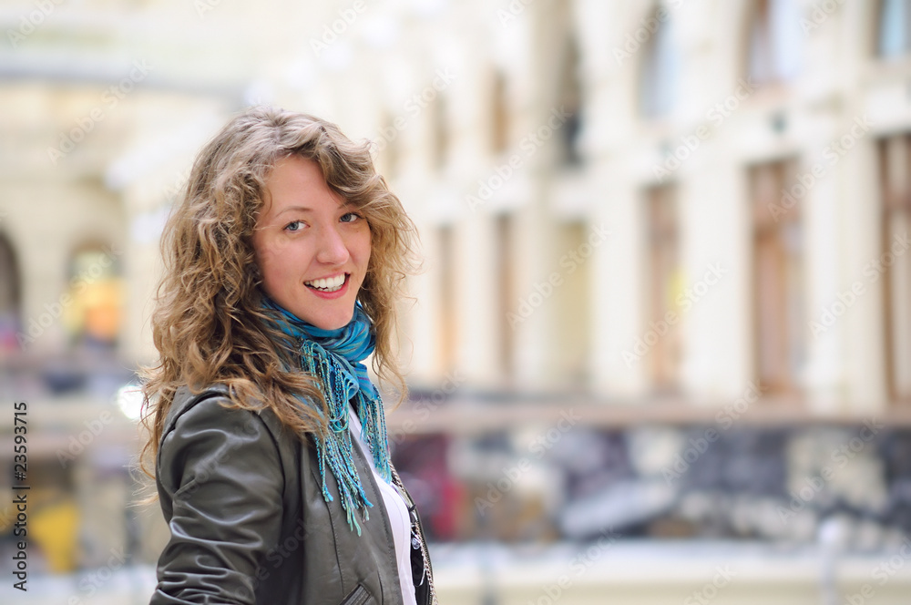 smiling woman in mall looking at camera