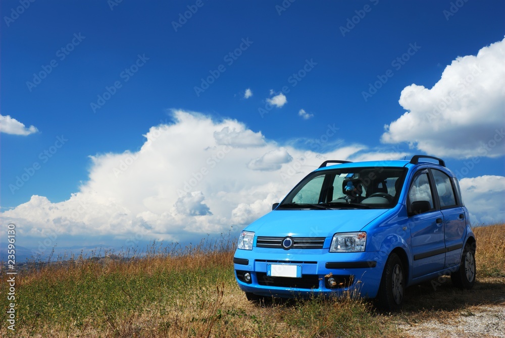 Bright pale blue modern car with beautiful nature background