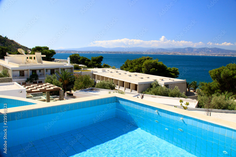 Fototapeta premium beautiful swimming pool surrounded by chairs and flowers
