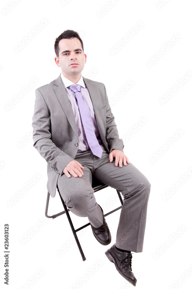 Young business man sitting on a chair Young business man sitting on a chair