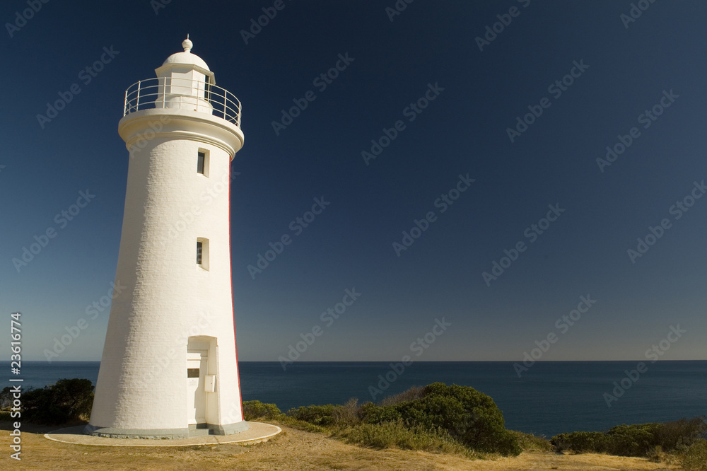 White Lighthouse Overlooks Ocean