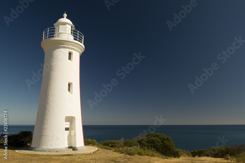 White Lighthouse Overlooks Ocean