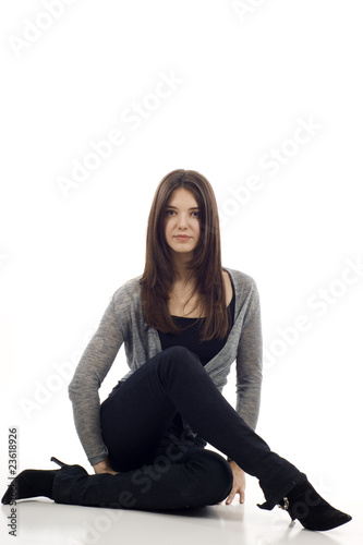 Studio Portrait of a Beautiful Woman Sitting on the Floor