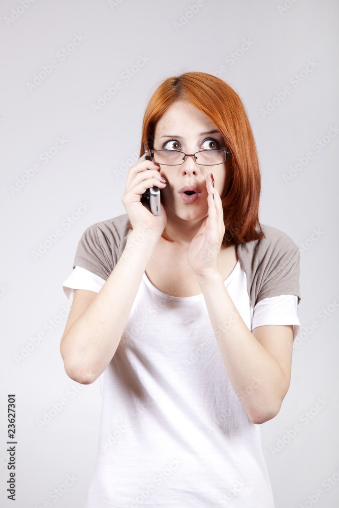 Young Businesswomen in white speaking by mobile phone. Young Businesswomen in white speaking by mobile phone.