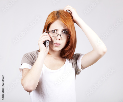 Young Businesswomen in white speaking by mobile phone.