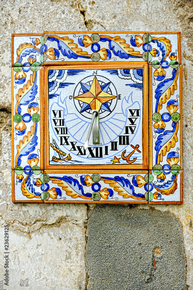 Ceramic sundial fixed upon a weathered wall near the city of Vil