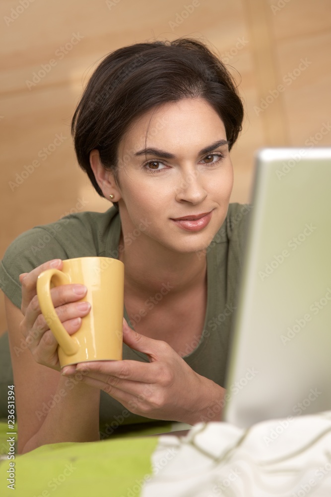 Portrait of woman having coffee in bed Portrait of woman having coffee in bed