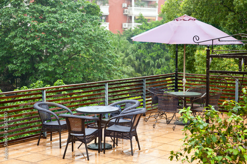 Patio rattan chairs and table  in raining