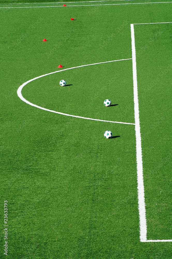 Football pitch with three soccer balls