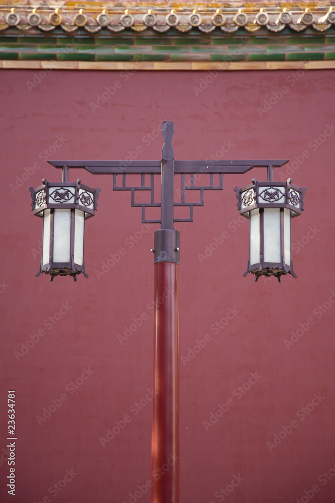 Ancient lantern against red wall