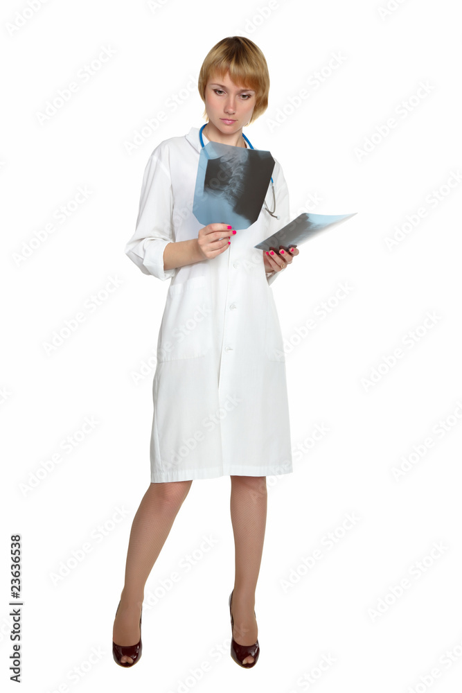 Pensive female doctor looking at the x-ray images. Pensive female doctor looking at the x-ray images.