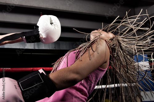 Blonde girl getting knocked out in a boxing ring Stock Photo | Adobe Stock