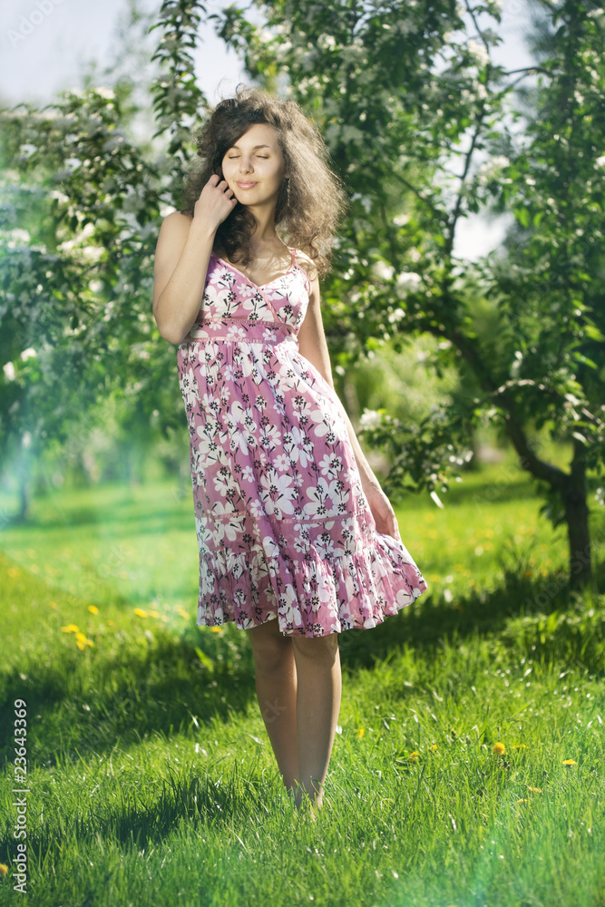 Beautiful girl in the flowered garden