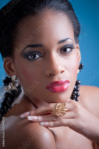 Beautiful black girl, studio portrait on blue background