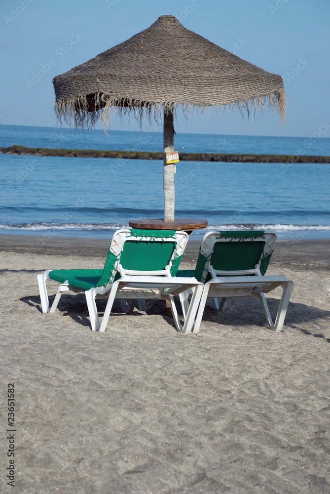 Beach umbrella and two loungers. Canary Islands Beach umbrella and two loungers. Canary Islands