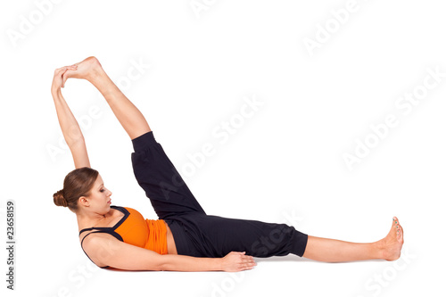 Woman Practicing Reclining Big Toe Yoga Pose photo
