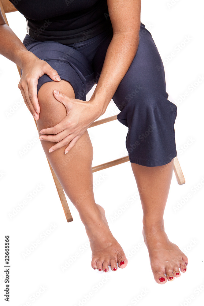 Woman suffering from pain on her knee, isolated