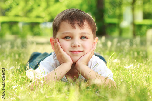 boy laying o the grass