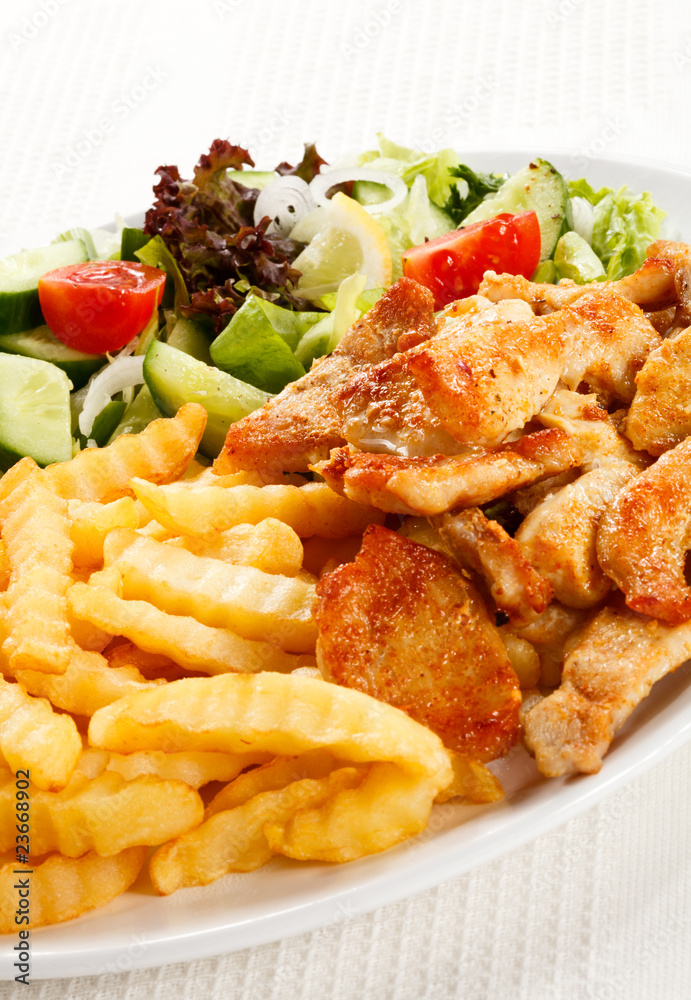 Grilled meat with fried potatoes and vegetables Grilled meat with fried potatoes and vegetables