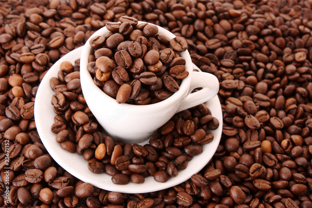 Small white cup of coffee with coffee grain on grain background Small white cup of coffee with coffee grain on grain background