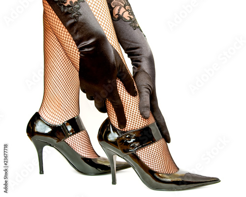 Woman hands in gloves touching leg isolated on white