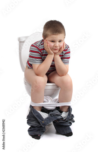 Little boy is sitting on toilet