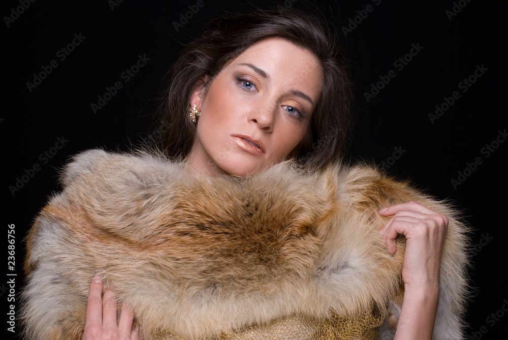 Close up portrait of young fashion woman in fur