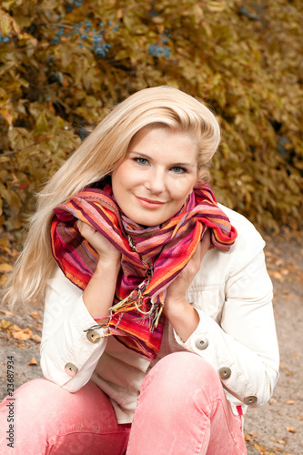 young pretty autumn woman in yellow tree forest outdoors