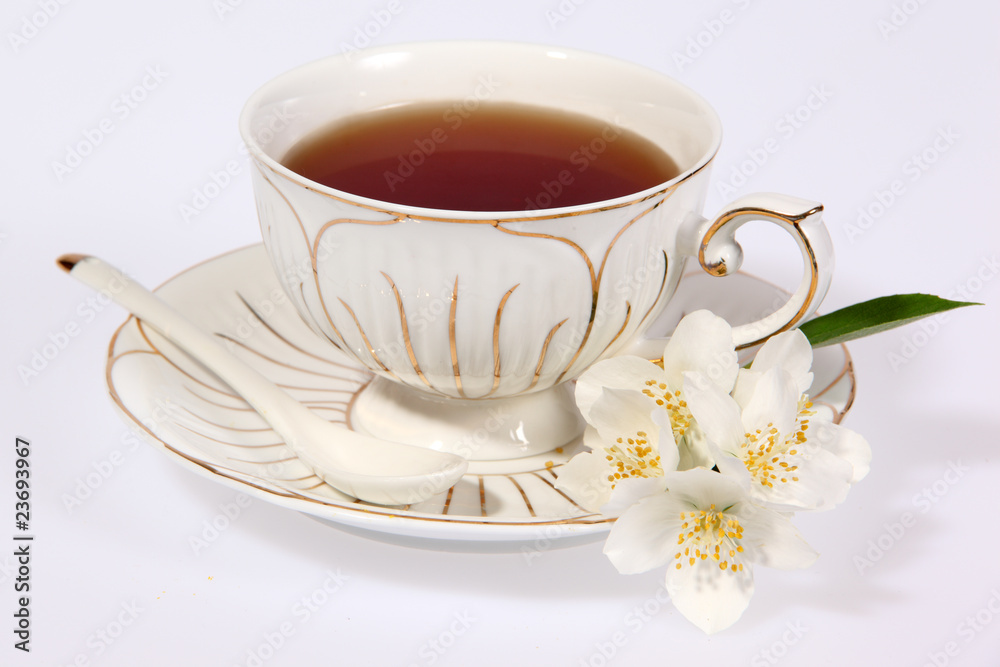 Cup of tea with jasmine flowers isolated on white. Cup of tea with jasmine flowers isolated on white.