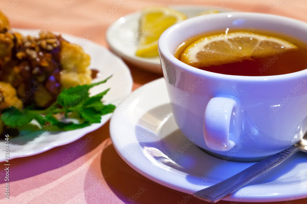 Tea with lemon and cakes. Shallow DOF Tea with lemon and cakes. Shallow DOF