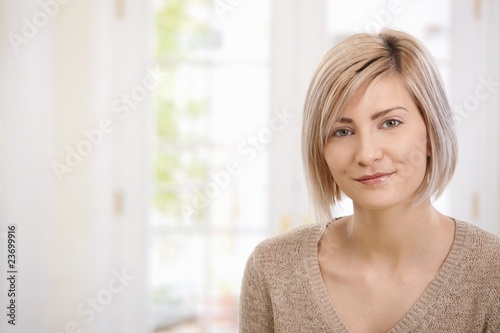 Portrait of young woman at home photo