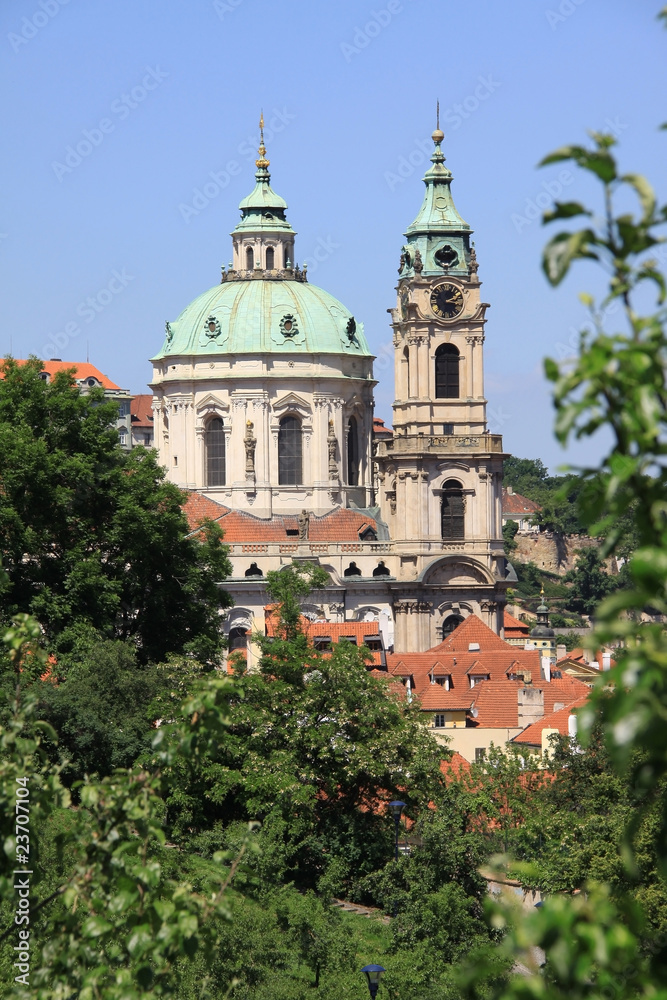View on Prague's St. Nicholas' Cathedral with flowering trees
